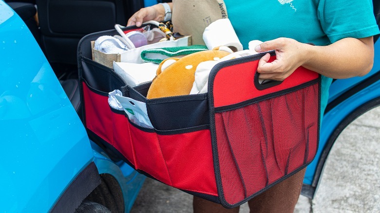 Simple Deluxe Car Trunk Organizer being carried