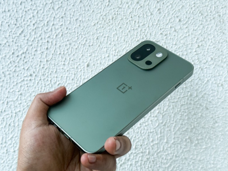 OnePlus 13s in the hands of a person.