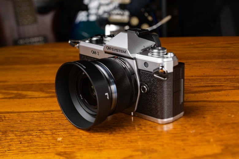 OM System OM-3 camera and lens placed on a table