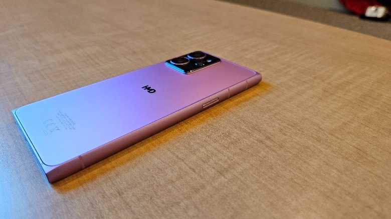 HMD Skyline on a light wooden table showing the back and right side in neon pink.