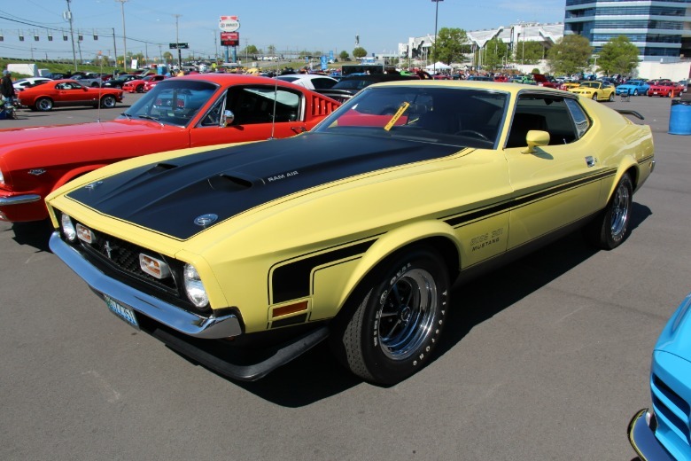 Yellow 1971 Ford Mustang Boss 351 parked at a car show