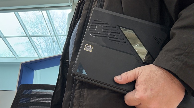 Man carrying a tablet.