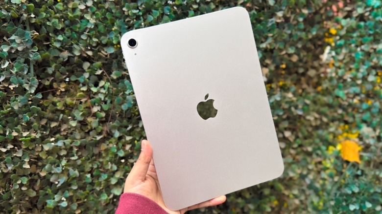 Holding iPad in hand.