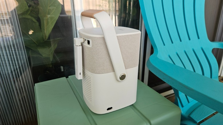 The Yaber T2 Plus Outdoor Projector showing the dongle and its angled HDMI adapter along with the left side power port.