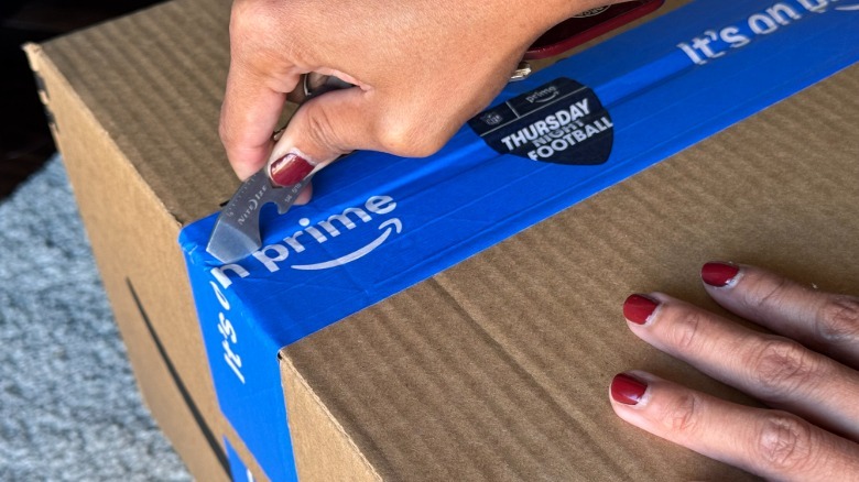 Author uses the Nite Ize DoohicKey to open a package