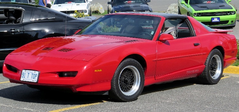 Red 1991 Pontiac Firebird Trans Am parked