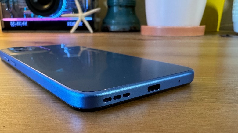 Moto G Play (2024) lying face down on hardwood showing the USB-C port.