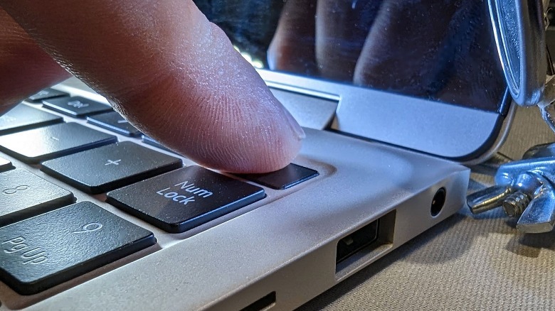 finger touching fingerprint scanner button