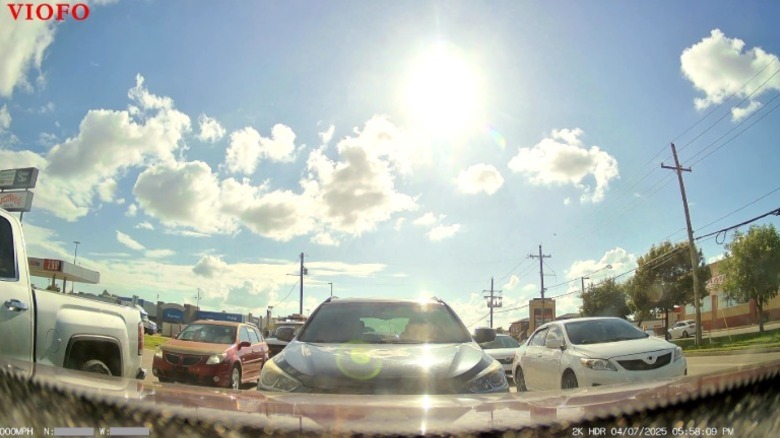 Vehicles and bright sunny day.