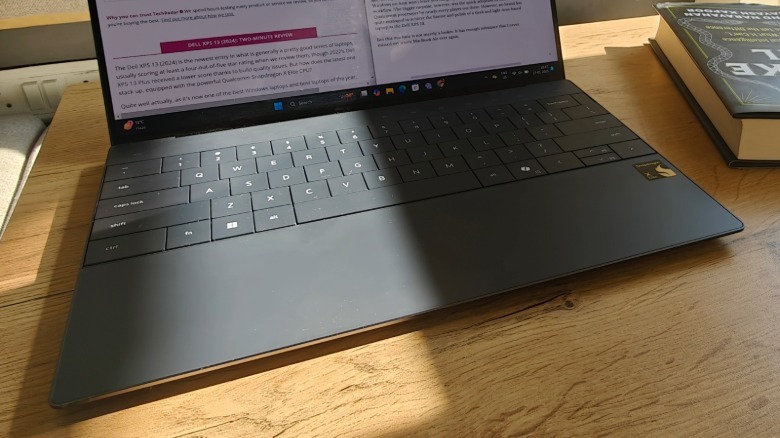 Top angled view of the keyboard deck and screen of the Dell XPS 13.