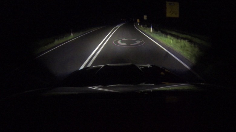 Ford car headlight projecting road condition information.