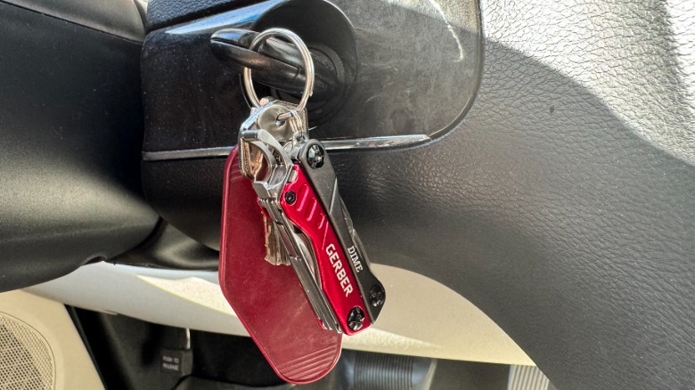 Gerber Dime multitool is attached to a car key in the ignition