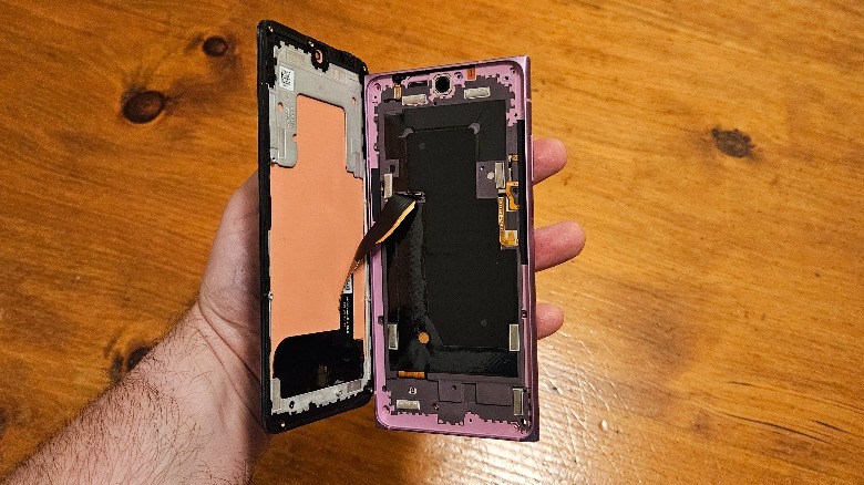 HMD Skyline with the display removed while being held in a hand.