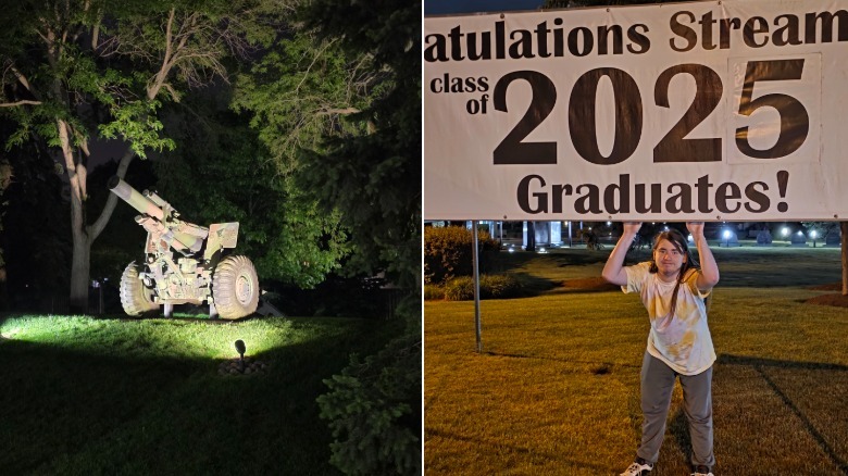 A canon at night and a man standing under a banner