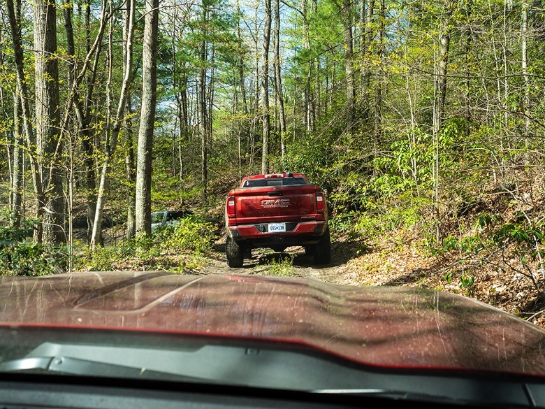 2023 GMC Canyon AT4X Edition 1 following another Canyon through the woods